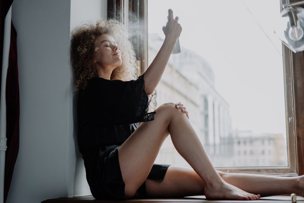 photo of woman with spray bottle