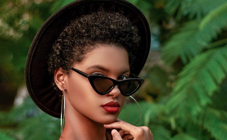 photo of woman with curly hair wearing a hat