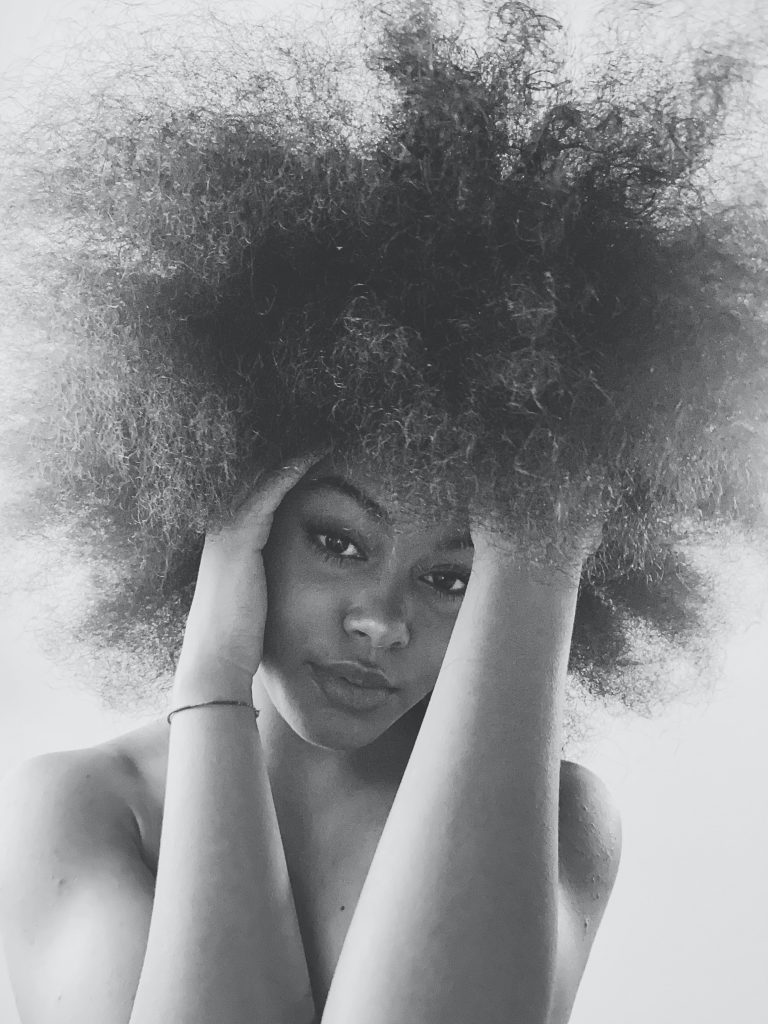 gray photo of woman with curly hair